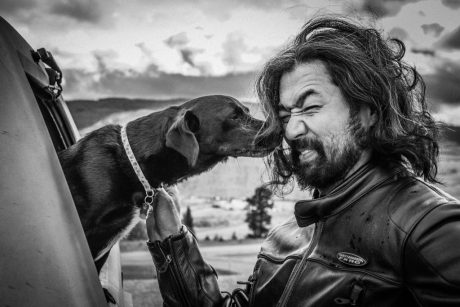 hairy Asian man with dog